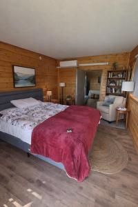 a bedroom with a large bed with a red blanket at Among the cherry trees - B&B 1 Hermon in Metulla