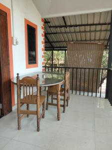 a table and chairs on the porch of a house at Casa De Olga in Vagator