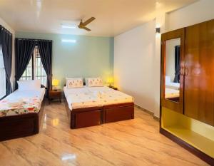 a room with two beds and a mirror at Sonnetta Residency in Cochin