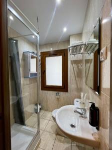 a bathroom with a sink and a shower at Hotel NIU a 50 m del Funicamp in Encamp +28 photos