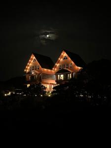 a house with lights on it at night at ADAM'S FORT by Dell'amore Havn in Vagamon