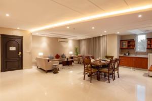 a dining room and living room with a table and chairs at Imperial - إمبريال in Riyadh +23 photos