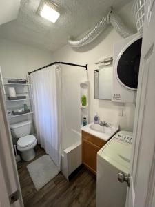 a small bathroom with a toilet and a sink at Malden Studio near Boston -- Private Stay with Kitchenette, Laundry in Malden