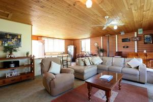 a living room with a couch and a table at Chloes Cabin Accommodation in White Beach