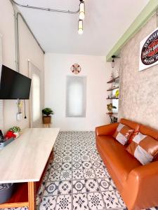 a living room with a couch and a tv at Papa House Standard Zone A in Ban Bang Saen (1)