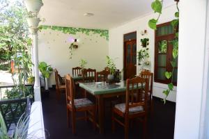 a dining room with a table and chairs at Ella travel rest inn in Ella