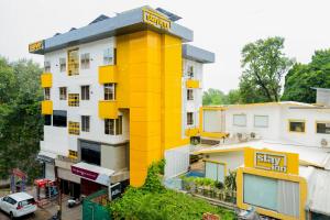 a yellow building with a sign on top of it at Stayinn Suites in Bhopal