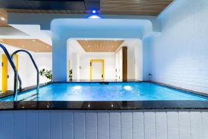 a pool in a building with an indoor swimming pool at Stayinn Suites in Bhopal