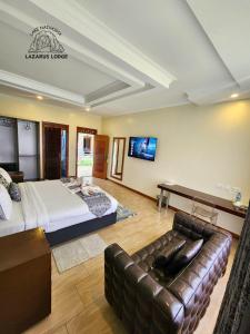 a bedroom with a bed and a couch in a room at Lake Naivasha Lazarus Lodge in Naivasha