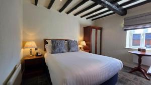 a bedroom with a white bed and a window at Windmill Village Hotel, Golf Club & Spa, BW Signature Collection in Coventry