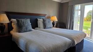 a hotel room with two beds and a window at Windmill Village Hotel, Golf Club & Spa, BW Signature Collection in Coventry