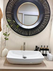 a bathroom with a white sink and a mirror at Papa House Standard Zone A in Ban Bang Saen (1)
