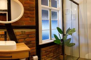 a bathroom with a window and a potted plant at Casa Enxaimel em Pomerode SC 01 in Pomerode +39 photos