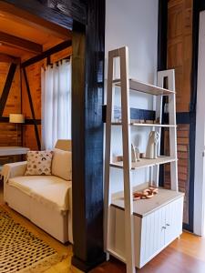 a living room with a book shelf and a couch at Casa Enxaimel em Pomerode SC 01 in Pomerode