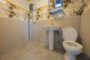 a bathroom with a toilet and a sink at Tawan Resort in Bophut