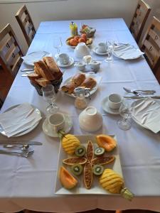 a table with a white table cloth with food on it at Le four à pain in Saint-Philippe
