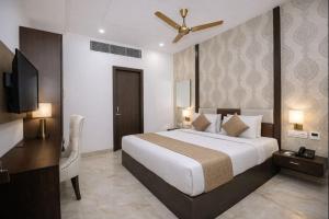 a hotel room with a bed and a ceiling fan at Hotel Tamanna 2 Minute Walk from Golden Temple in Amritsar