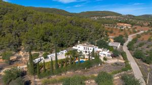 an aerial view of a house with trees and a road at Finca Can Rosa Ibiza, private pool, a nature getaway in Santa Gertrudis de Fruitera