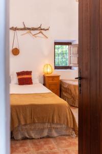 a bedroom with two beds and a window at Finca Can Rosa Ibiza, private pool, a nature getaway in Santa Gertrudis de Fruitera +74 photos