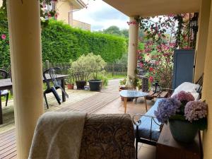 a patio with a couch and a table with flowers at La Venta in Arguedes