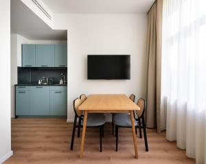 a kitchen and dining room with a table and chairs at Limehome Athens Agora in Athens