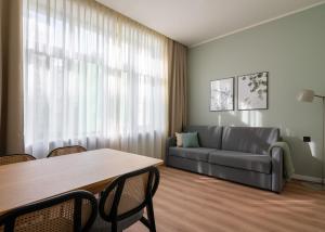 a living room with a couch and a table at Limehome Athens Agora in Athens