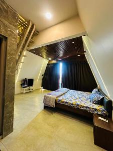 a bedroom with a bed in the middle of a room at Celebrations Party House in Kolhapur +43 photos