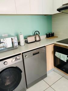 a kitchen with a dishwasher and a washer at The blyde-Luxury one bedroom apartment in Pretoria