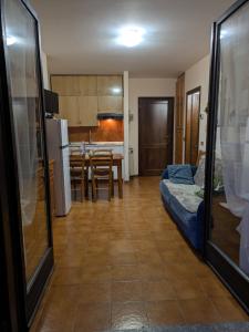 a kitchen and a living room with a couch and a table at Appartamento Cedro - Centro Aprica - Park - WiFi in Aprica
