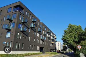 a building on a street next to a street sign at The Parkview Studio Apartment in Tallinn