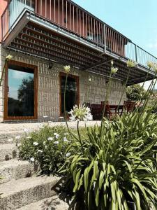 a house with a balcony and some plants at Casa das Castanhas - Cinfães, Viseu in Cinfães