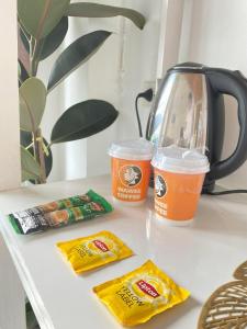 a table with two cups of coffee and snacks on it at Exclusive Sea View in Chon Buri
