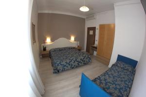 Postel nebo postele na pokoji v ubytování Hotel Moderno