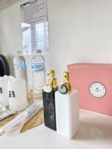 a table with two perfume bottles and a pink box at Exclusive Sea View in Chon Buri