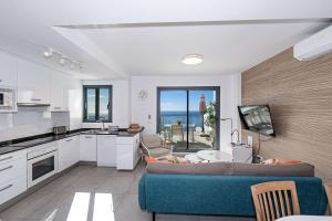 a kitchen and living room with a couch and a table at Terrazas de Ladera Duplex 7 Casasol in Nerja