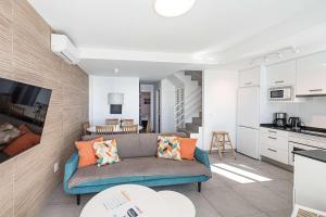 a living room with a couch and a kitchen at Terrazas de Ladera Duplex 7 Casasol in Nerja