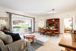 a living room with a couch and a table at Villa Margarita Punta Prima by Escape Home in Punta Prima
