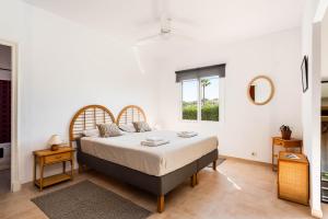 a bedroom with a bed and a window at Villa Margarita Punta Prima by Escape Home in Punta Prima +22 photos