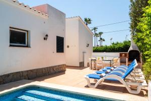 a villa with a swimming pool and a house at Villa Margarita Punta Prima by Escape Home in Punta Prima