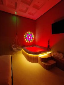 a red room with a tub with a stained glass window at Erbanova al Borgo Suite in Taranto