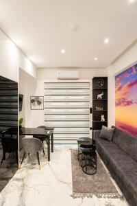 a living room with a couch and a table at Serenity Nook by Sefi in Mesochórion