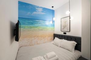 a bedroom with a bed with a picture of the beach at Serenity Nook by Sefi in Mesochórion