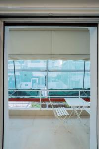 a window with a white chair in a room at Serenity Nook by Sefi in Mesochórion