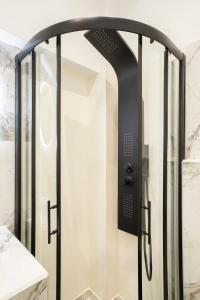a shower with a glass door in a bathroom at Serenity Nook by Sefi in Mesochórion +31 photos