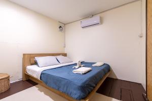 a bedroom with a bed with towels on it at Searyn Lanta in Ko Lanta +11 photos