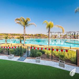 an image of a swimming pool with palm trees at The blyde-Luxury one bedroom apartment in Pretoria
