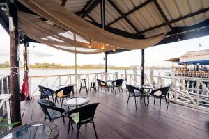 a deck with tables and chairs on a boat at Searyn Lanta in Ko Lanta