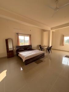 a bedroom with a bed and a table in it at Laya hotels in Chintāmani