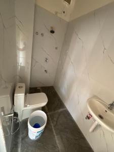 a small bathroom with a toilet and a sink at Laya hotels in Chintāmani
