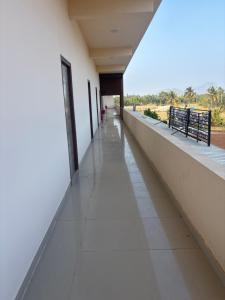 an empty hallway of a building with a view at Laya hotels in Chintāmani